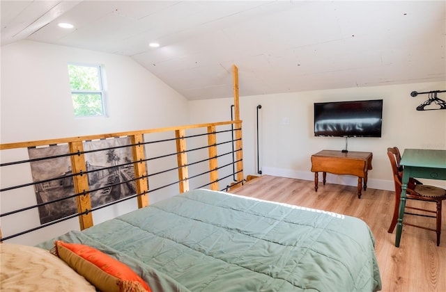 bedroom with hardwood / wood-style floors and lofted ceiling