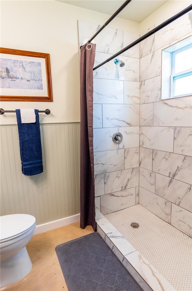 bathroom featuring toilet and walk in shower