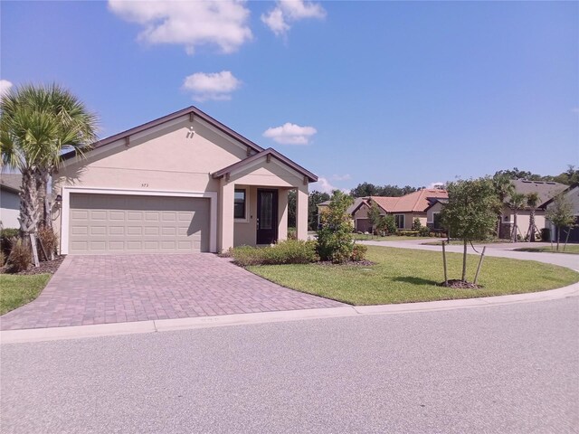 view of front of home with a garage and a front yard