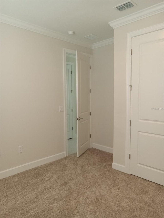 carpeted empty room with crown molding