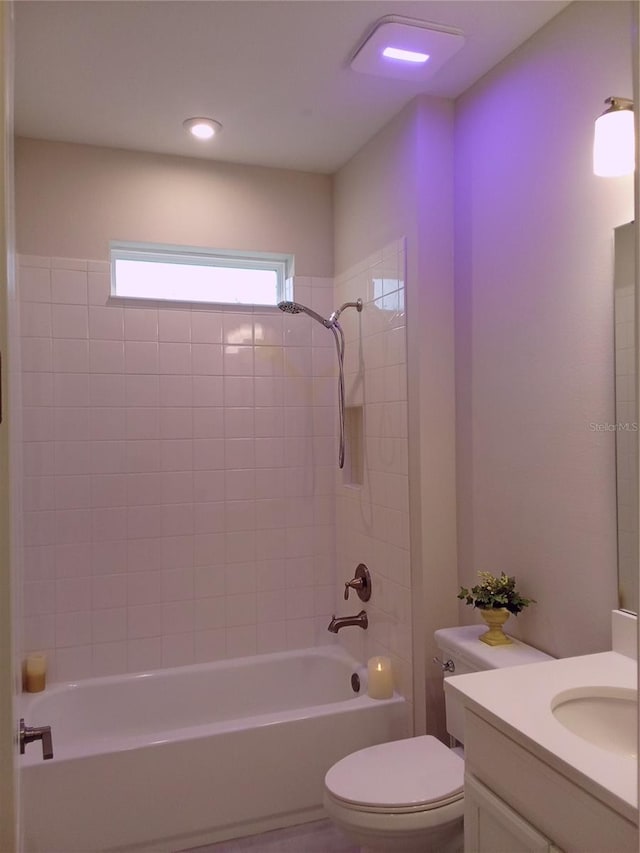 full bathroom featuring vanity, toilet, and tiled shower / bath