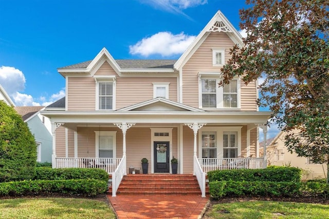 victorian-style house featuring covered porch