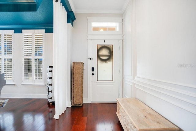 foyer featuring dark hardwood / wood-style floors and ornamental molding