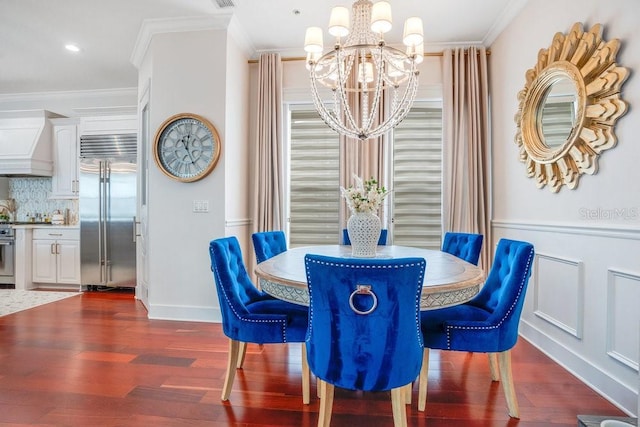 dining area featuring a notable chandelier, crown molding, and dark wood-type flooring