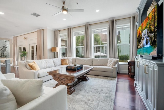 living room featuring ceiling fan, plenty of natural light, dark hardwood / wood-style floors, and ornamental molding