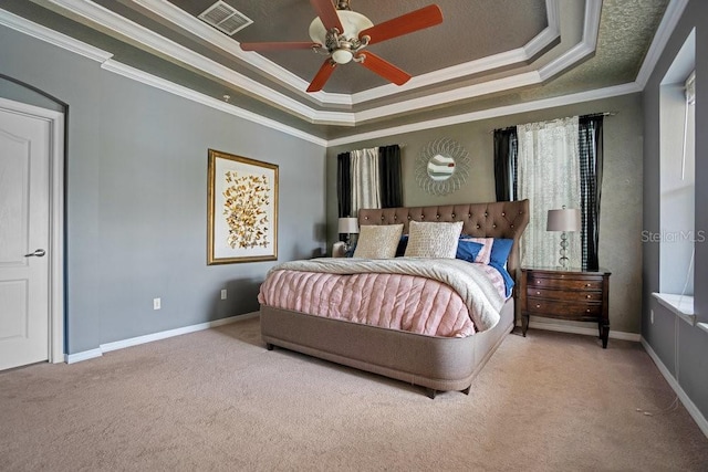 bedroom featuring ceiling fan, crown molding, and a tray ceiling