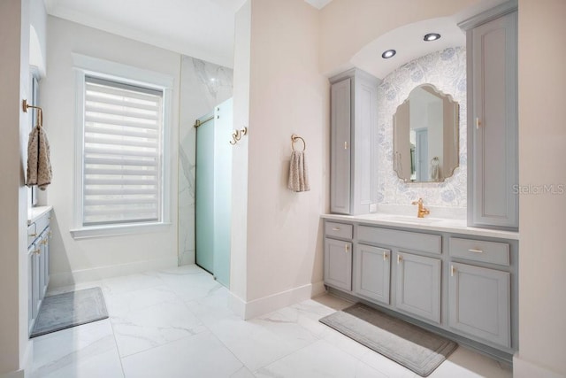 bathroom with plenty of natural light, a shower with shower door, and vanity