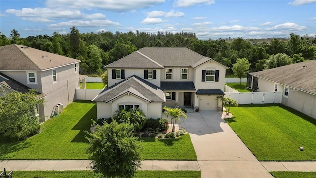 view of front facade featuring a garage and a front lawn