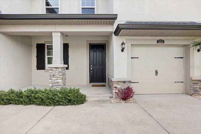 entrance to property with a porch and a garage