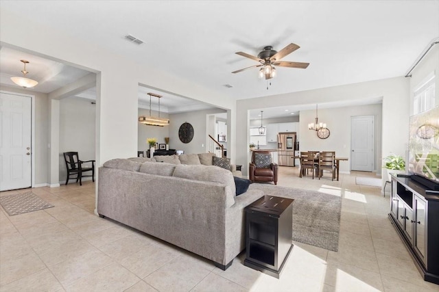 living room featuring light tile patterned flooring and ceiling fan with notable chandelier