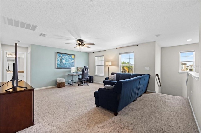 carpeted living room with a textured ceiling and ceiling fan