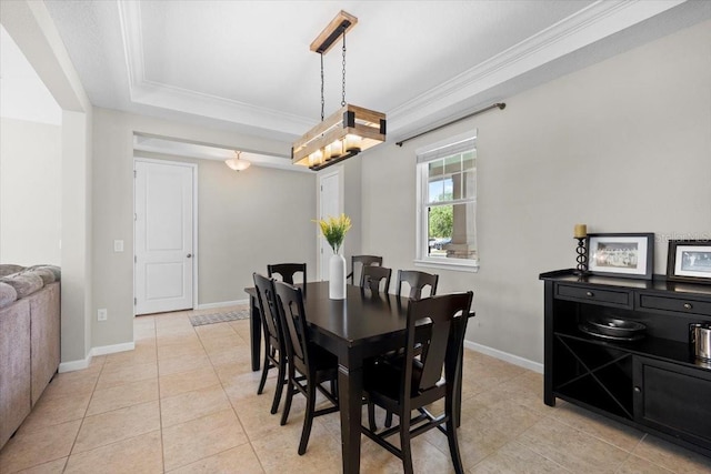 dining area featuring a tray ceiling, crown molding, and light tile patterned floors