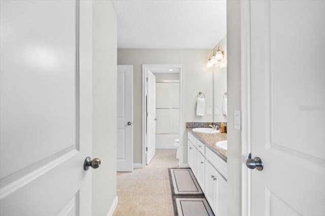 full bathroom with tile patterned floors, a textured ceiling, vanity, enclosed tub / shower combo, and toilet