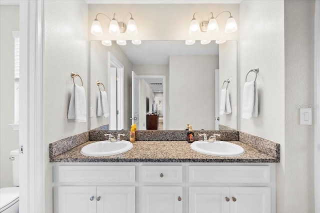 bathroom featuring vanity and toilet