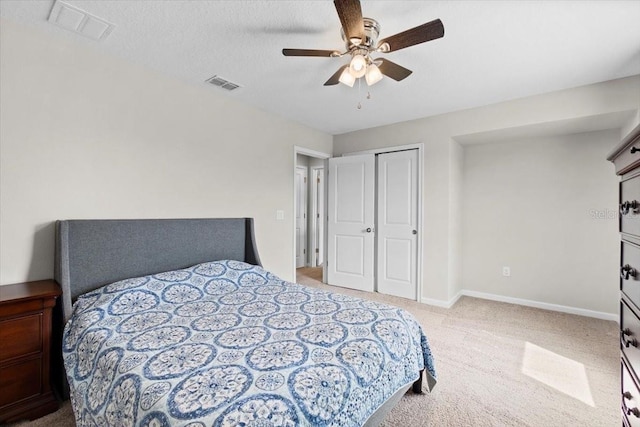 carpeted bedroom featuring ceiling fan, a closet, and a textured ceiling