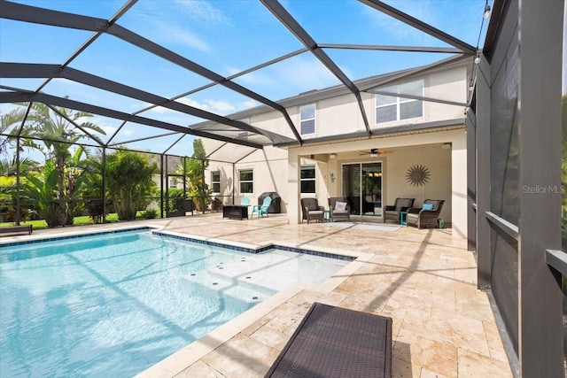 view of swimming pool featuring ceiling fan, a patio area, and a lanai