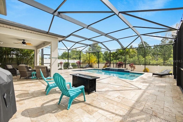 view of pool featuring pool water feature, ceiling fan, a lanai, and a patio