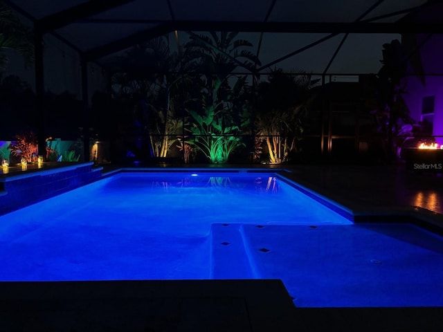 pool at twilight with glass enclosure