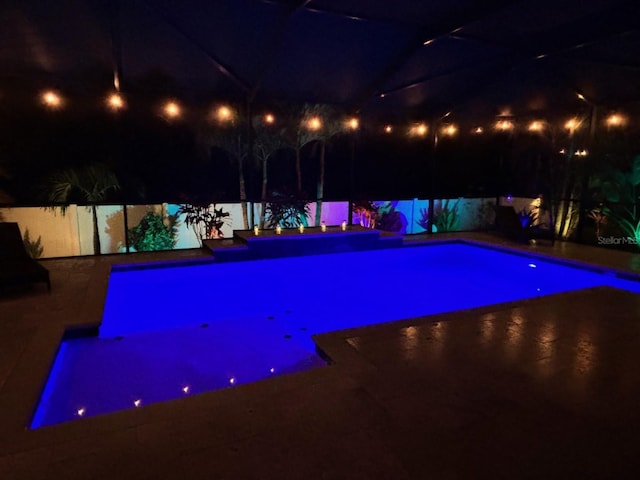 view of pool at night