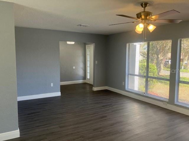 spare room featuring ceiling fan and dark hardwood / wood-style flooring