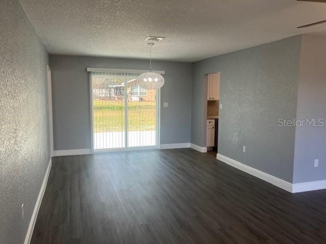 unfurnished dining area featuring a textured ceiling, ceiling fan, and dark hardwood / wood-style floors