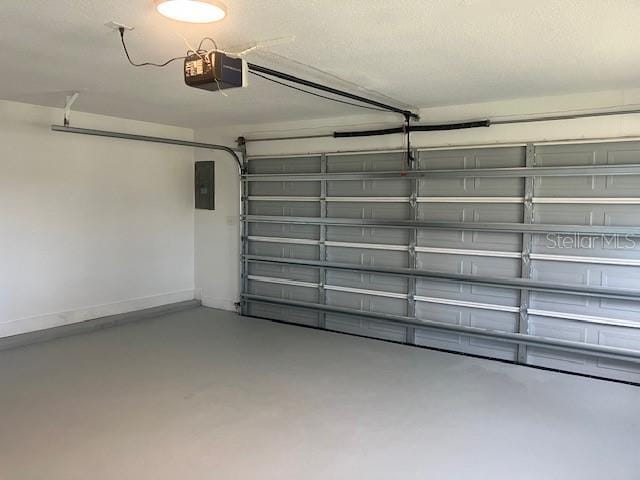 garage with electric panel and a garage door opener