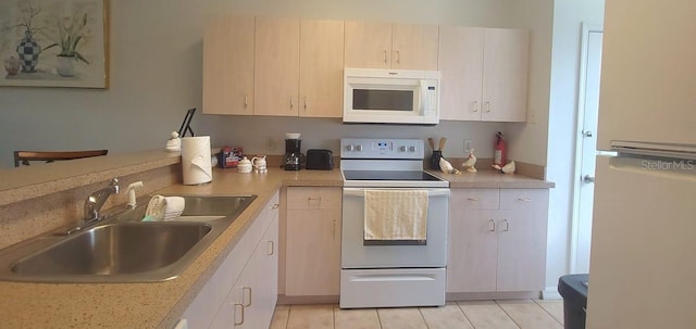 kitchen featuring white appliances and sink