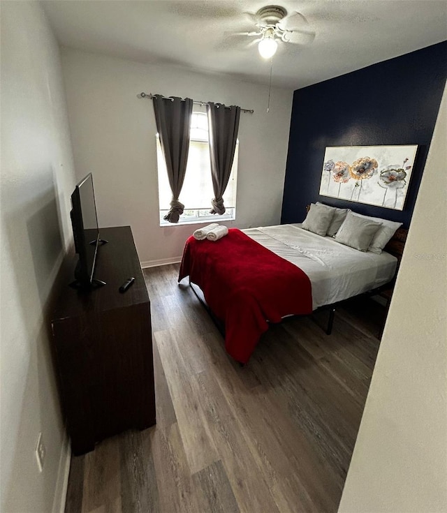 bedroom with hardwood / wood-style floors and ceiling fan