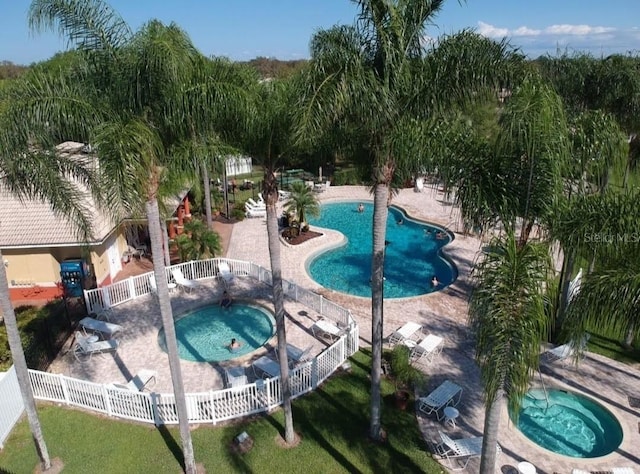 view of pool with a community hot tub and a patio