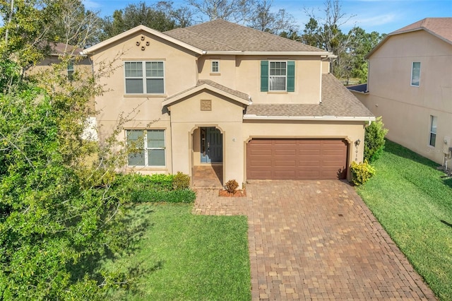 view of front of house featuring a garage and a front lawn