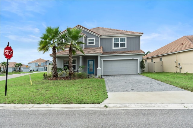 view of front of home with a garage and a front lawn