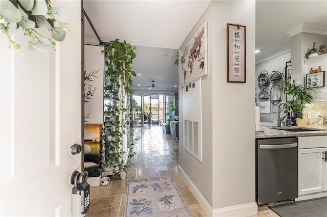 corridor with crown molding and sink