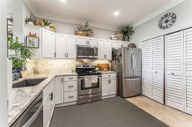 kitchen featuring white cabinets, light stone counters, sink, and stainless steel appliances