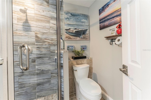 bathroom with an enclosed shower and toilet