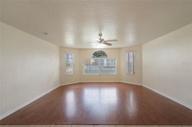 unfurnished room featuring tile patterned floors, ceiling fan, and a textured ceiling