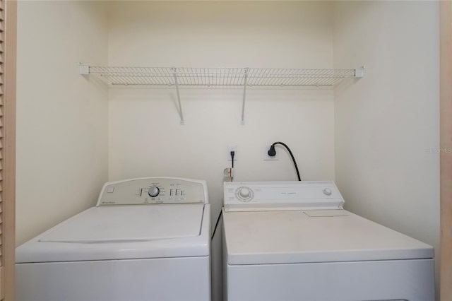 clothes washing area with washing machine and clothes dryer