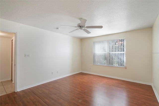 spare room with ceiling fan, a textured ceiling, and hardwood / wood-style flooring