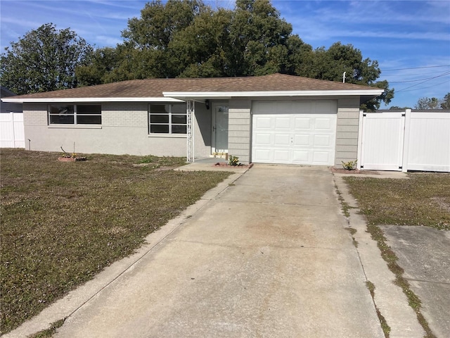 ranch-style home featuring a garage and a front lawn