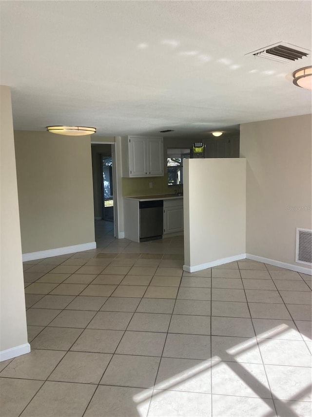 interior space featuring light tile patterned floors and stainless steel dishwasher