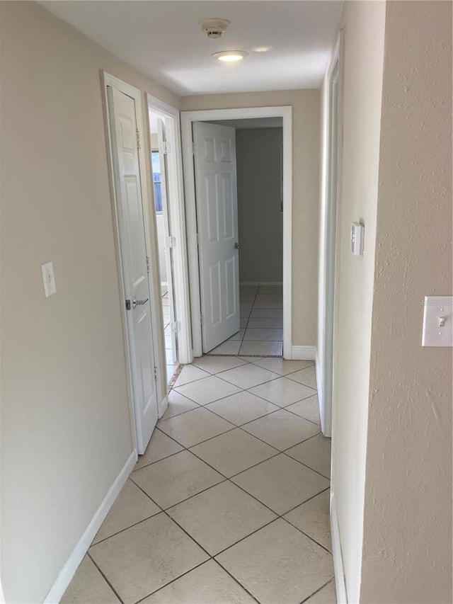 hallway with light tile patterned floors