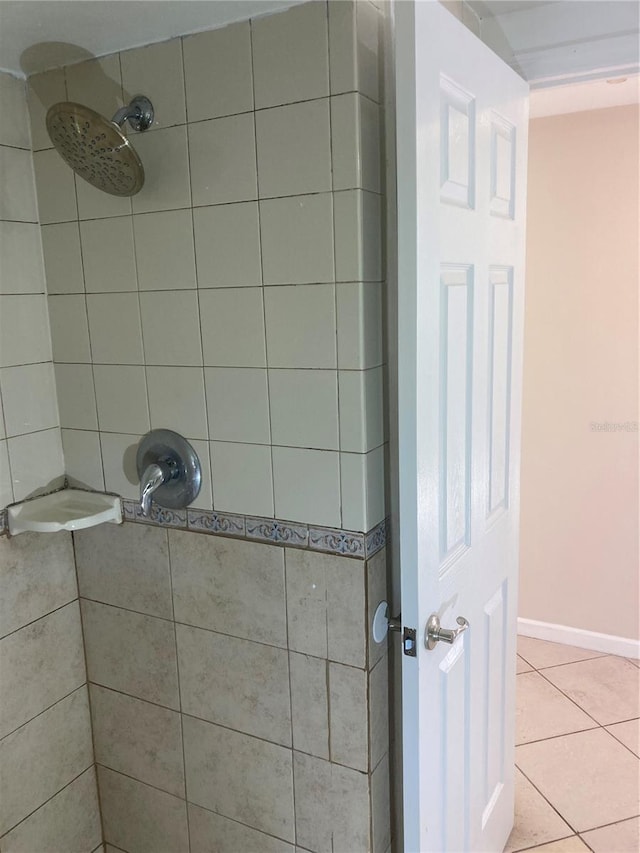 bathroom with tile patterned floors and tiled shower