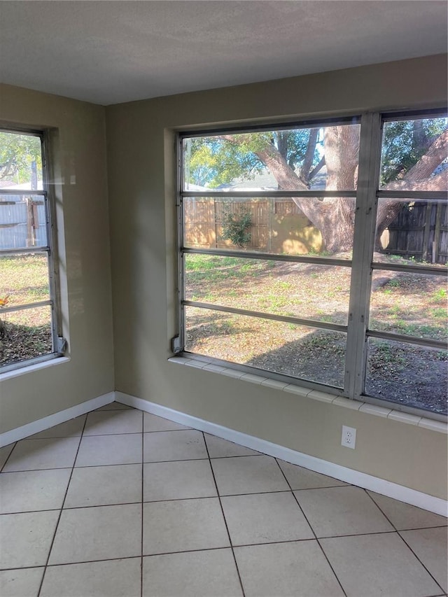 interior space with tile patterned flooring and a healthy amount of sunlight