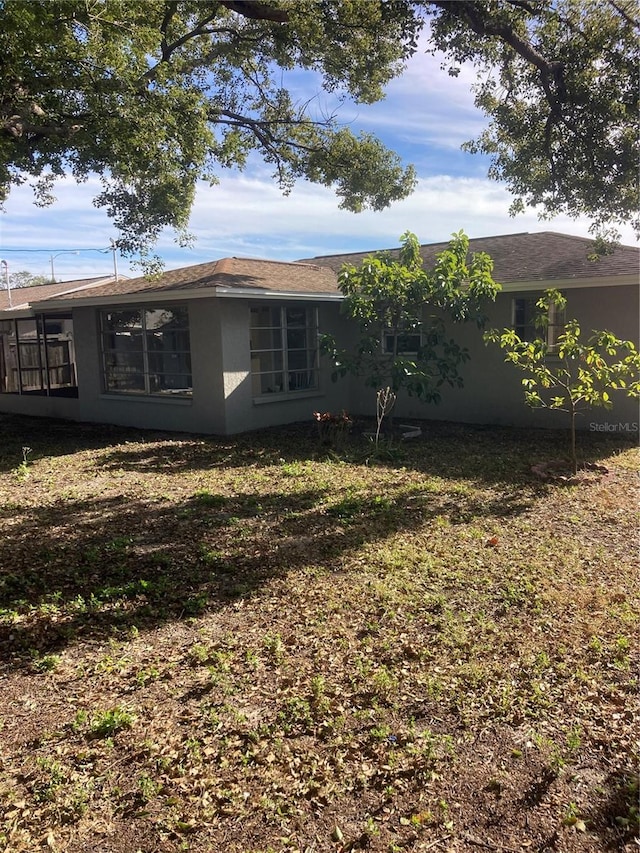 rear view of house featuring a lawn