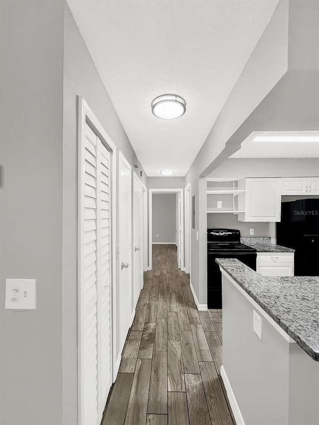 corridor featuring a textured ceiling