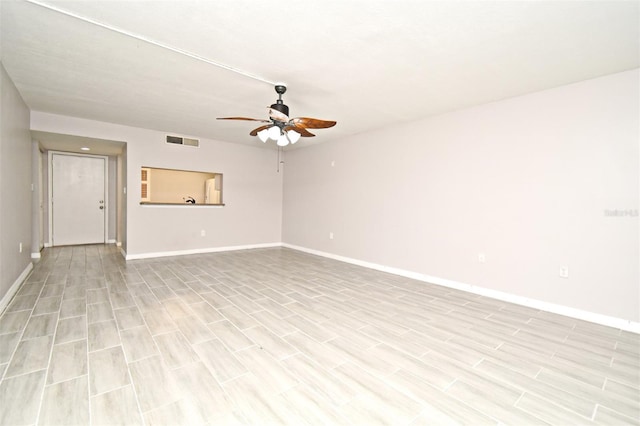 empty room with ceiling fan and light hardwood / wood-style floors