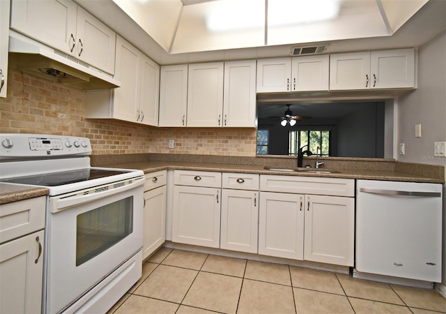 kitchen with white cabinetry, sink, white appliances, and light tile patterned floors