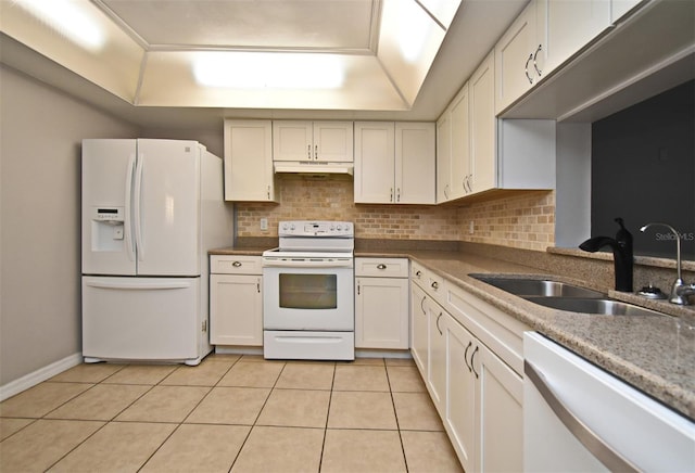 kitchen with tasteful backsplash, white appliances, sink, and light tile patterned floors