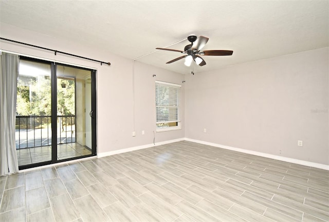 spare room with ceiling fan and light wood-type flooring