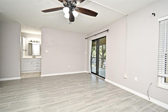 spare room featuring ceiling fan and sink