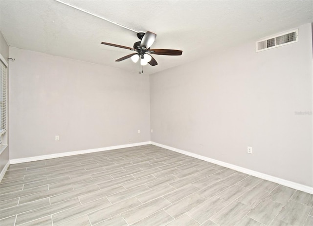 spare room with ceiling fan and a textured ceiling